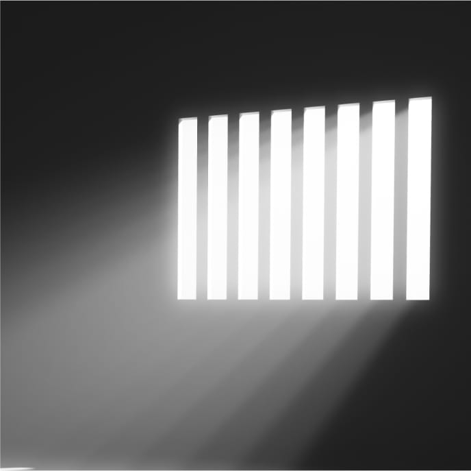 Light shining through barred window in a dark room